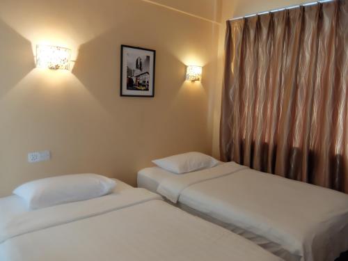 Ένα ή περισσότερα κρεβάτια σε δωμάτιο στο YaJu Hotel