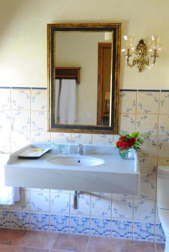 a bathroom with a white sink and a mirror at Font del Pas in Beceite