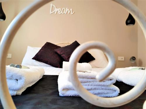 a pile of towels sitting on top of a bed at Grand Hotel in Newcastle