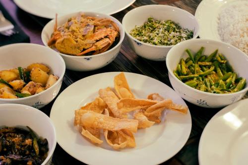 a table with plates of food and bowls of different foods at Mount Lodge Boutique Hotel in Mount Lavinia