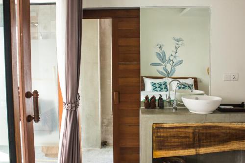 a bathroom with a sink and a bowl on a counter at Sarina Boutique Hotel in Phnom Penh