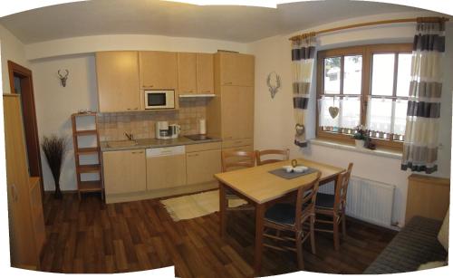 a kitchen and dining room with a table and chairs at Alpenapart Walch in Jerzens