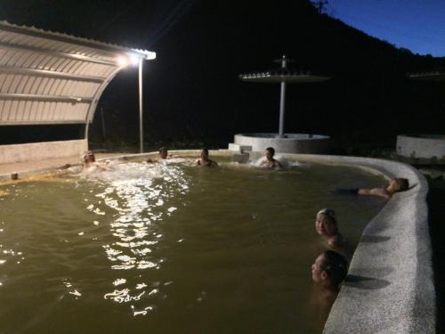 a group of people in a swimming pool at night at Jin Ping Homestay in Haiduan