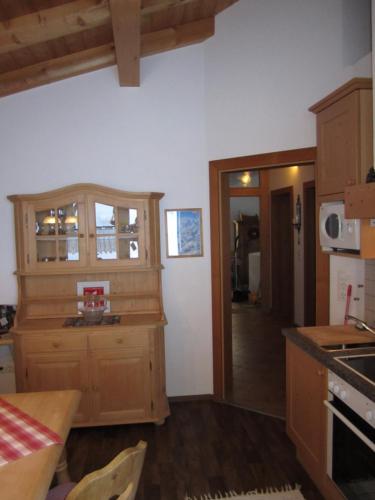 a kitchen with wooden cabinets and a counter top at Alpenapart Walch in Jerzens