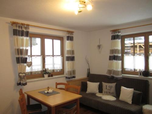 a living room with a couch and a table at Alpenapart Walch in Jerzens