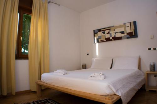 a bedroom with a bed with two towels on it at Casa Martello in Levico Terme