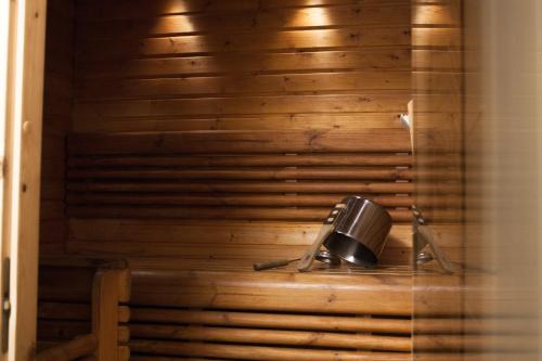 a telephone sitting on a shelf in a wooden wall at Levin Alppitalot Alpine Chalets in Levi
