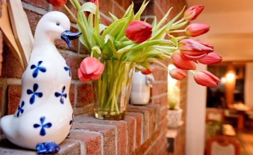 a group of vases and flowers on a brick wall at Hotel am Katharinenholz in Potsdam