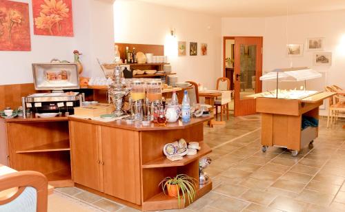 a room with wooden cabinets and tables and chairs at Hotel am Katharinenholz in Potsdam