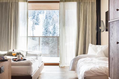 Un ou plusieurs lits dans un hébergement de l'établissement Hotel Tofana