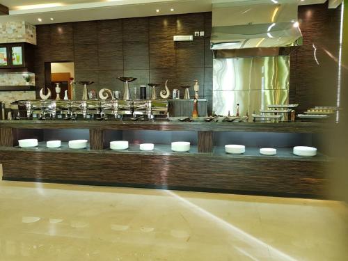 a room with a counter with bowls and utensils at Thwary Hotel Suites in Riyadh