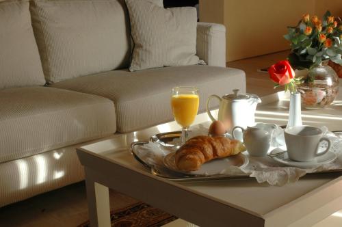 a coffee table with a tray of breakfast foods and orange juice at Avalon Boutique Suites Hotel in Rhodes Town