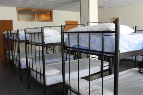a group of bunk beds in a room at Albergue Ferramenteiro in Portomarin