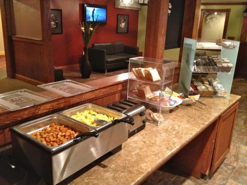 a kitchen with a counter with food on it at Travelodge by Wyndham Miramichi New Brunswick in Miramichi