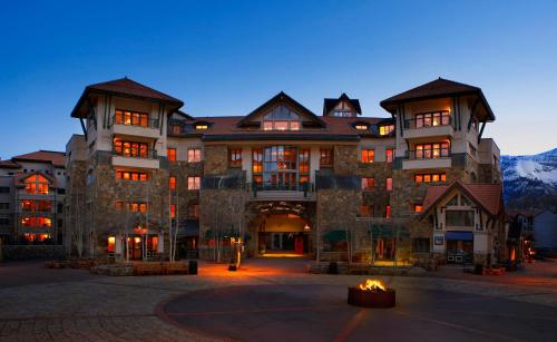 a large building with a fire in front of it at Fairmont Heritage Place, Franz Klammer Lodge in Telluride