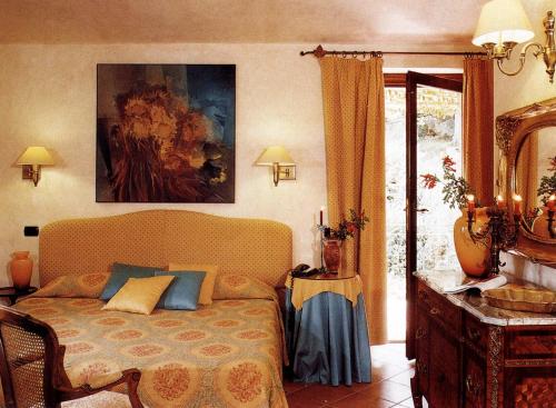 Postel nebo postele na pokoji v ubytování L'Agnata di De André Boutique Hotel