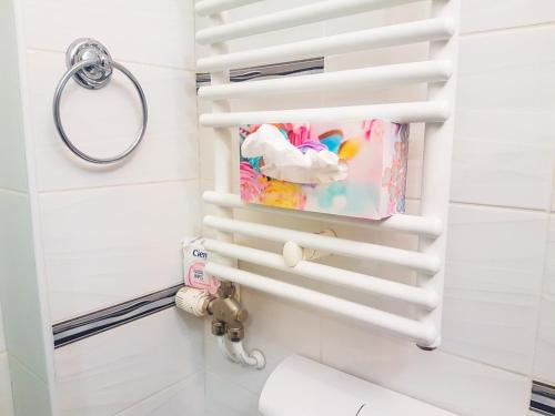 a bathroom with a white toilet and a towel at Smještaj Natalija in Osijek
