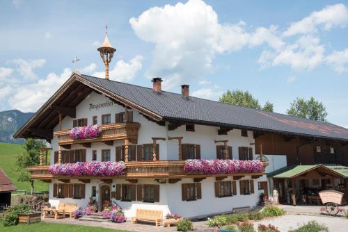 a large building with flowers on the front of it at Bio Angererhof in Bad Häring