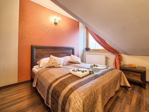 a bedroom with a bed with two towels on it at VisitZakopane - Malibu Apartment in Zakopane