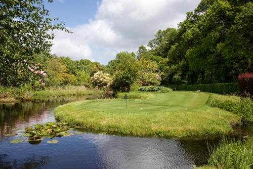 a golf course in the middle of a river at Gidleigh Park- A Relais & Chateaux Hotel in Chagford