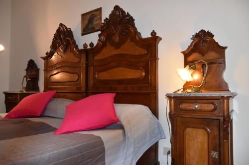 ラパッロにあるSpacious luxury apartment in Rapallo centerのベッドルーム1室(大型木製ベッド1台、赤い枕付)