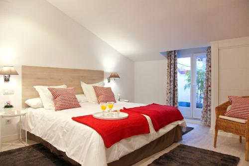 sypialnia z dużym łóżkiem i czerwonym kocem w obiekcie Feelathome Madrid Suites Apartments w Madrycie