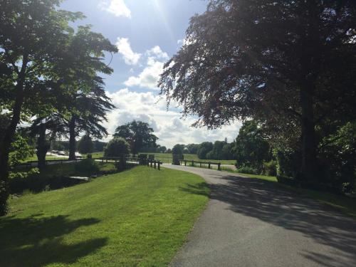a path in a park with trees and grass at Castlemartyr Holiday Mews 3 bed by Trident Holiday Homes in Castlemartyr
