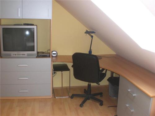 a desk with a computer and a chair in a room at Apartman JITKA Protivin in Protivín