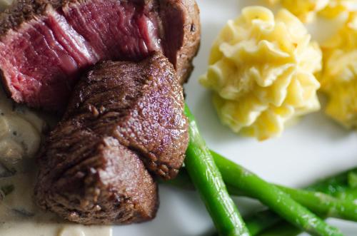 a plate of food with steak and mashed potatoes and green beans at Hotel Bad Langensalza Eichenhof in Bad Langensalza