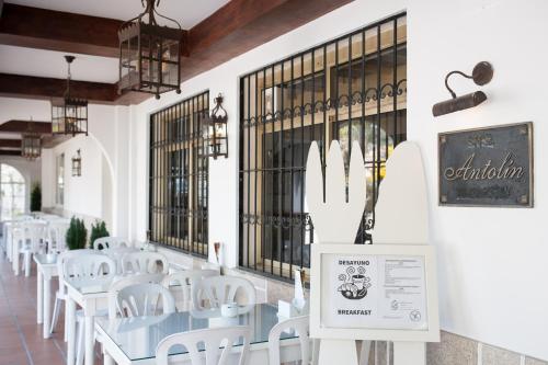a restaurant with white tables and white chairs at Hostal Antolín in Redondela