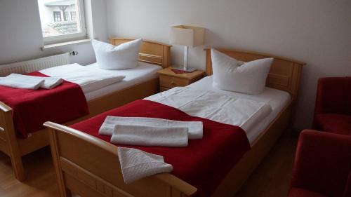 A bed or beds in a room at Pension Haus Maria