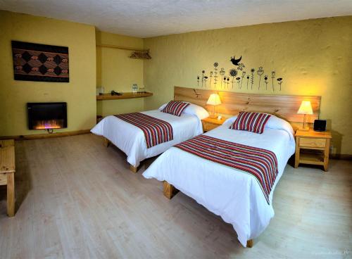 Postel nebo postele na pokoji v ubytování Killawasi Lodge