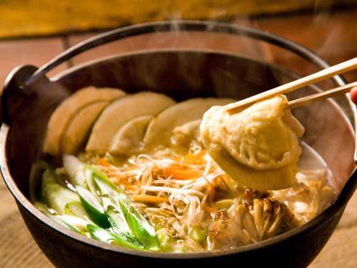 a bowl of soup with a spoon in it at Smile Hotel Hachinohe in Hachinohe
