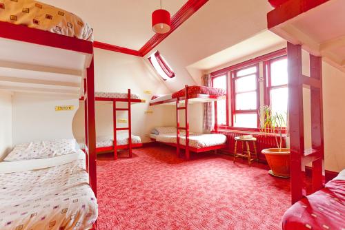 a bedroom with two bunk beds and a window at Fort William Backpackers in Fort William