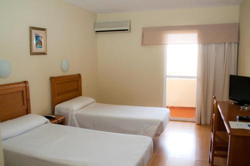 Tempat tidur dalam kamar di Hotel Anfora