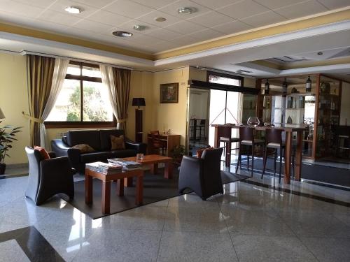a living room with a couch and a table at Hotel Avión by Bossh! Hotels in Vigo