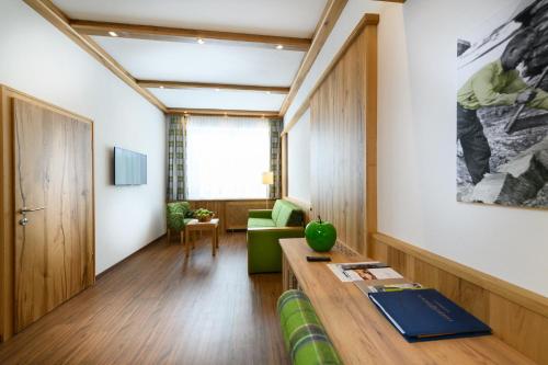 a living room with a couch and a table at Wellnesshotel Schönruh - Adults only in Seefeld in Tirol