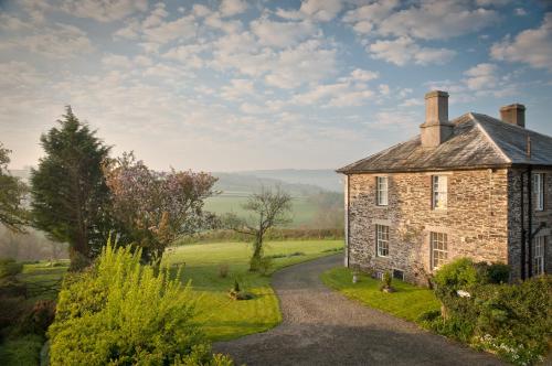 an old stone house on a road at Beera Farmhouse in Milton Abbot