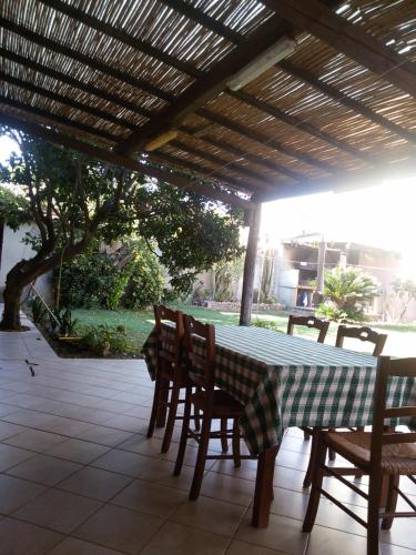 a table and chairs under a pergola on a patio at La Casa Rossa in Riola Sardo