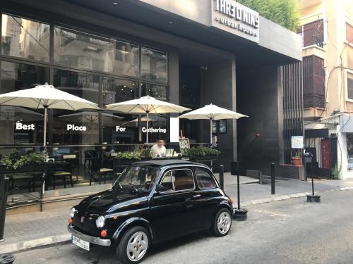 a small black car parked in front of a restaurant at Three O Nine Hotel in Beirut