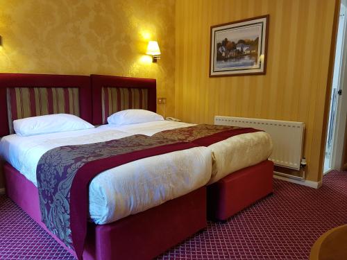 Postel nebo postele na pokoji v ubytování Buckatree Hall Hotel