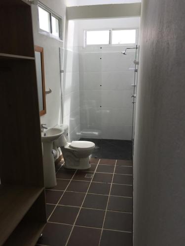 a bathroom with a toilet and a sink at Finca La Ranchera No. 2 in Tarso
