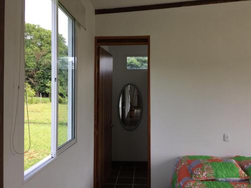 a hallway with a mirror and a window at Finca La Ranchera No. 2 in Tarso