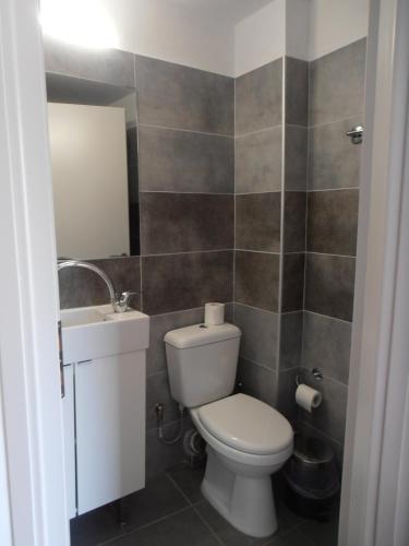 a bathroom with a toilet and a sink at Diana Rooms in Chania