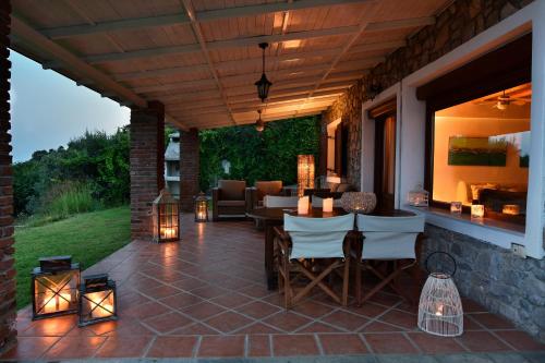 an outdoor patio with a table and chairs and lights at Agia Kali Villas in Skiathos Town