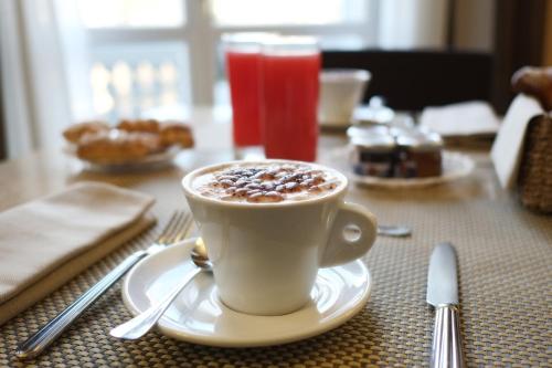 a cup of coffee sitting on a table at Hotel Principe Di Torino in Turin