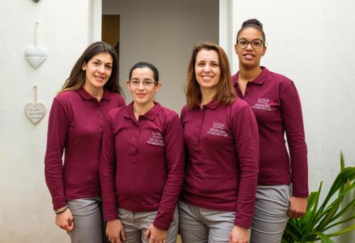 a group of women in purple shirts posing for a picture at Loulé Coreto Hostel in Loulé