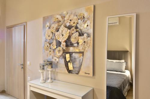 a bedroom with a table with a painting on the wall at Agia Kali Villas in Skiathos Town