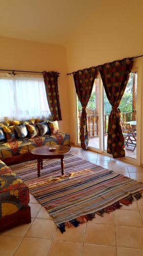 a living room with a couch and a table at L'échappée belle Benslimane in O Ben Slimane