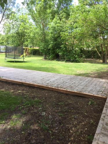 a walkway in a park with a playground at Relais de la Venise verte in Coulon